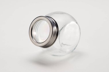 Gümüş kapaklı boş cam kavanoz, beyaza izole edilmiş.