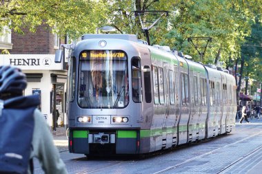 Hannover, Lower Saxony, Germany - October 25, 2024: Tram line number 10 driving through Limmer to Hauptbahnhof central station. clipart