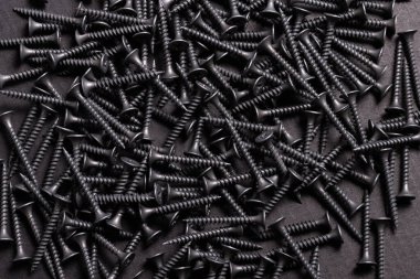 Metal, Stainless Steel Self Tapping Screws on black wooden backg clipart