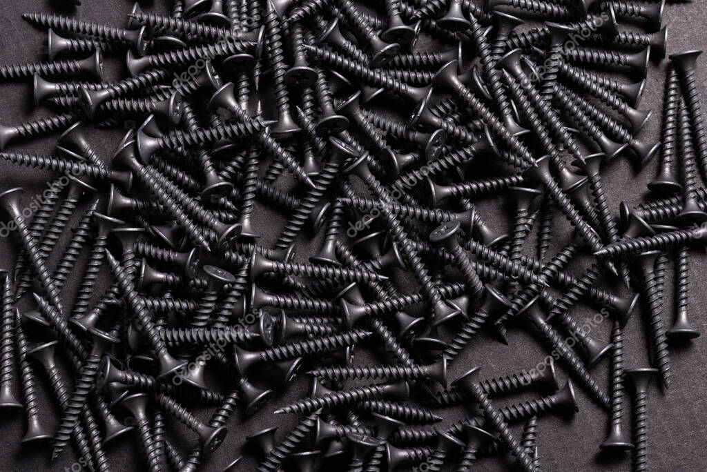 Metal, Stainless Steel Self Tapping Screws on black wooden backg