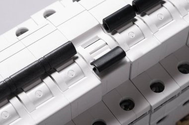 Plastic electrical circuit breaker, device, on grey background