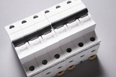 Plastic electrical circuit breaker, device, on grey background