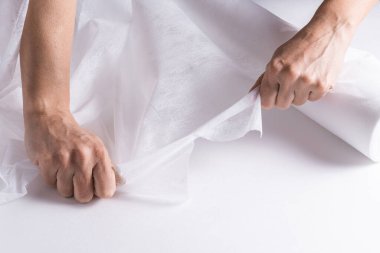 Woman hands working with  Covering Roll for Medical Bed