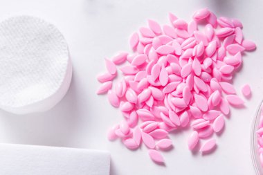 Hot film wax for depilation procedure on white background