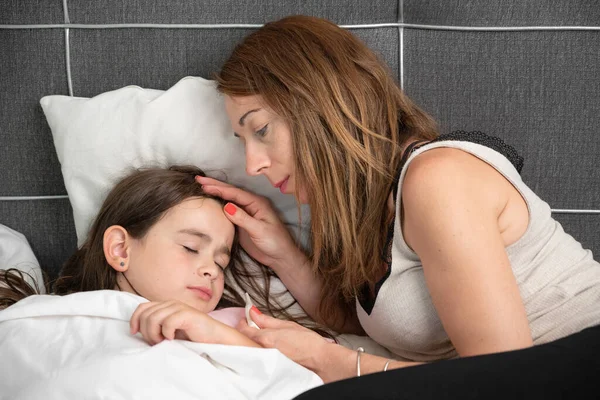 stock image Mother taking care of her sick daughter.High quality photo