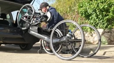 Engelli bir sporcu. Bisikletini sürmeye hazır hale getiriyor. Yüksek kalite 4k görüntü
