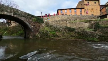 İspanya 'nın Cantabria kentindeki Potes köyünde Deva Nehri üzerinde bir ortaçağ köprüsü görülüyor. Yüksek kalite 4k görüntü