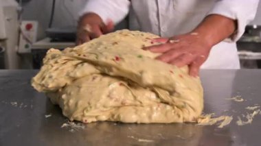 Pastry chef kneading the dough for the production of artisan panettone. High quality 4k footage
