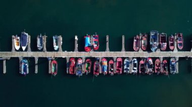 Aerial drone footage of fishing boats moored at the marina. High quality 4k footage