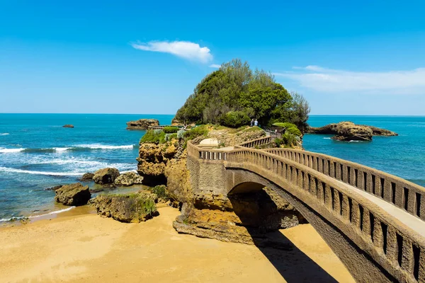 stock image Stone bridge to the Rocher du Basta, the scenic rock and major landmark in the coast of Biarritz, France. High quality photography.