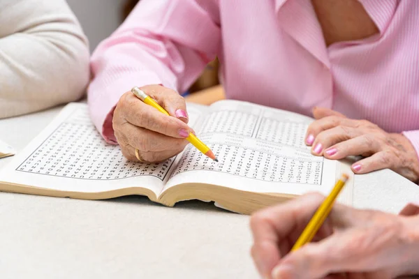 Hands Senior People Solving Together Word Search Quiz Nursing Home — Stock Photo, Image