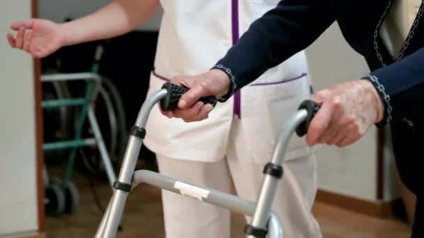 Nurse Assists Her Senior Patient Folding Walker Recuperation Elderly Seniors — Stock Video
