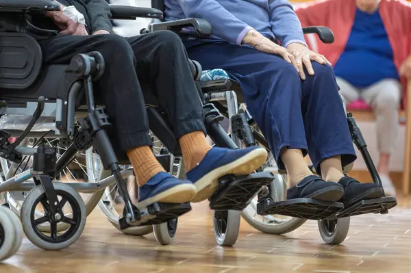 Senior patients in wheel chair at nursing home. High quality photo