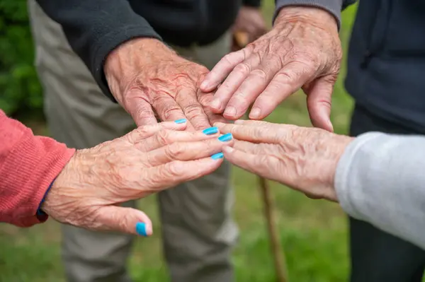 Close up view of Seniors people holding hands together express care and psychological support, empathy, hope, concept of old people health care, group therapy. High quality photo