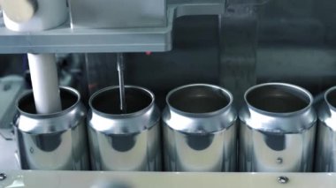 İçecek imalatında taşıyıcı bant makinesinde içki işlemleri için boş yeni alüminyum kutular. Yiyecek ve içecek endüstriyel iş konsepti. Yüksek kalite 4k görüntü