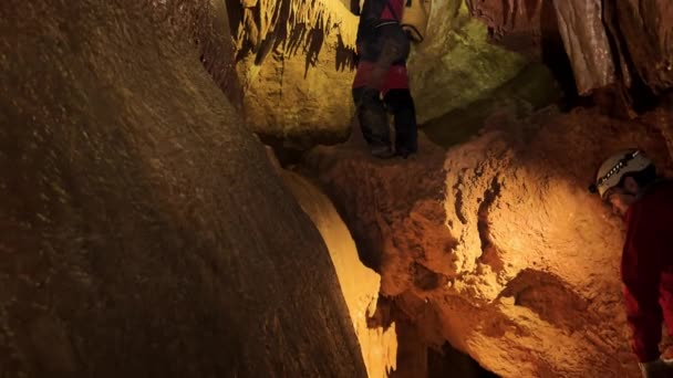 Groupe Spéléologues Intérieur Une Grotte Éclairés Par Des Projecteurs Explorant Vidéo De Stock