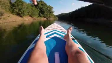 Gölde kayak yaparken. Güzel bir manzarada kano süren bir adam portresi. Yaz konsepti sırasında su sporları. Güzel, sakin, rahatlatıcı, sıcak manzaralı bir yer. Yüksek kalite 4k görüntü