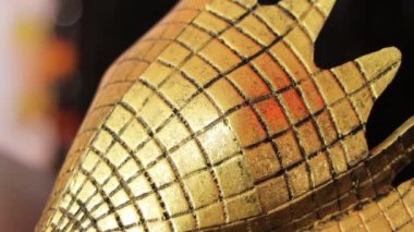 Altın renkli lüks metal kartal maskesi. Kareli bir dokusu var ve çok zarif görünüyor. Sol taraf. Solu kapat..