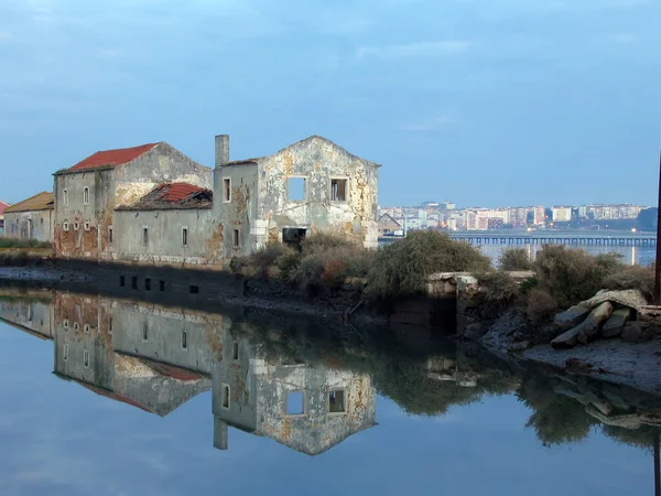 Old ruined Tide Mill and water mirror at Seixal Bay. Being centuries old, its one of the surviving Tide Mills in Europe