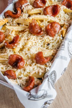 French fries with sausage and many sauces that arouse hunger and the desire to eat