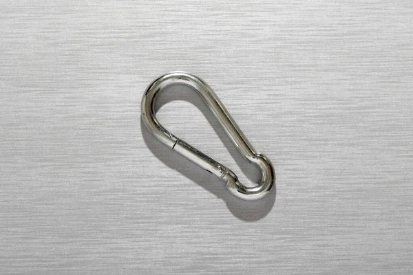 Top View Shiny Metal Carabiner Located Gray Surface Light Studio — Stock Photo, Image