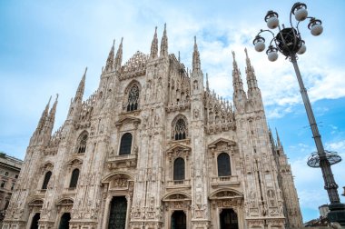 Duomo di Milano, ya da Milan Katedrali, birçok kule ve detaylarıyla izleyicinin üzerinde yükselişe geçer.