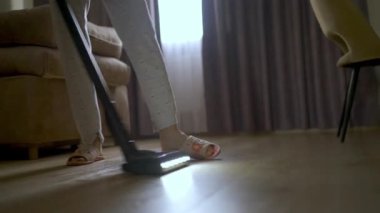 Evi elektrik süpürgesi temizliyor.