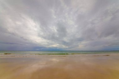 White sand. Bright tropical summer sun and blue sky with light clouds.
