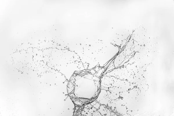 big splash of water isolated on white background near transparent  vineglass