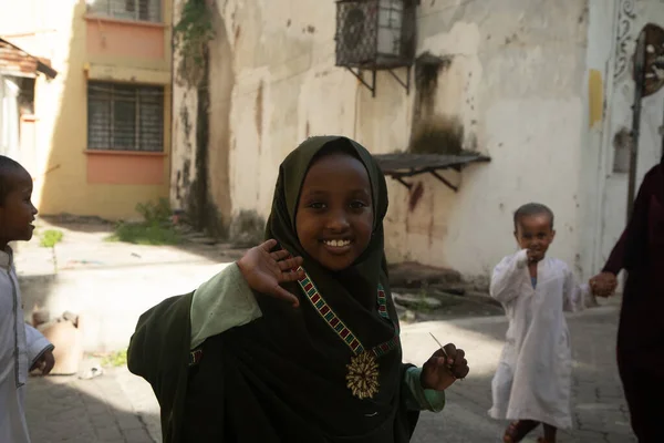 stock image Mombasa,Kenya Africa. 19.10.2019 narrow street of the old city with people and cars.Modern and ancient. children near Sunday school madrasah