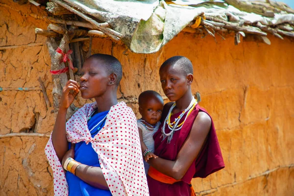 Kenya Afrika, 16 Ekim 2019. Afrika kabilesinden Maasai 'li kadınlar köydeki evlerinde kilden yapılmış ulusal elbiseler giyiyorlar.