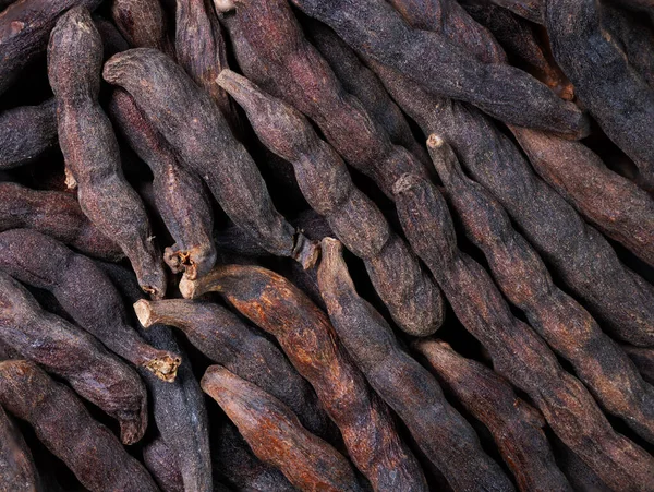 stock image super macro shot of heap exotic spice selim pepper ,xylopia acthiopica, from Senegal in details very close. Ideal food and spice background.