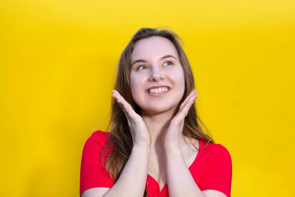 Stock image Closeup photo of pretty happy lady wear red dress and looking empty space. isolated yellow color background. Young emotional girl concept. Copy space