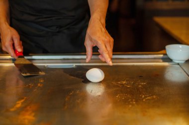 Şefin elleri teppanyaki yerine spatula ile. Sebze pişirmek et ve deniz ürünleri sıcak hibachi ızgara masasında. Geleneksel Japon mutfağı. Teppan gösterisi