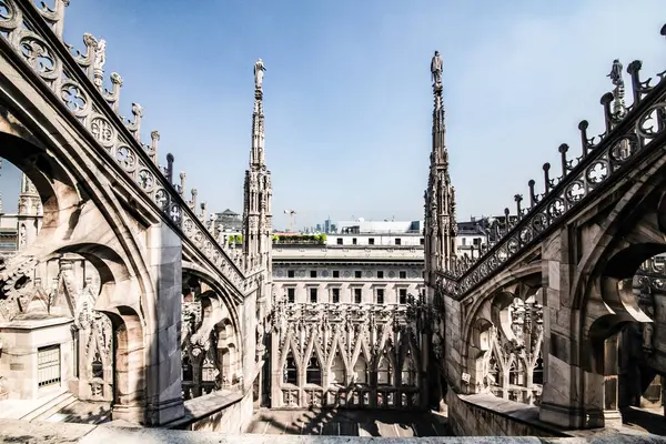 Milano, İtalya 31 Temmuz 2018. Milano Katedrali Duomo di Milano 'nun çatısında Gotik kuleler ve beyaz mermer heykeller var. İtalya 'daki Milano meydanında turistik bir eğlence. Geniş açı görünümü eski Gotik mimari