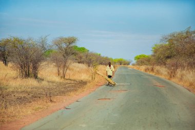 Antsirabe, Madagaskar 19 Ekim 2023. Morondava 'dan Antsirabe' ye giden yol Madagaskar 'ın ortasındaki boş otlaklar ve köyden geçiyor. Yollarda yürüyen insanlar