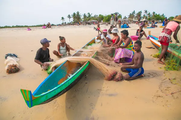 stock image Batavia,western Madagascar, Toliara province.18 october 2023. Inhabitants Madagascar traditional fishing village fold their nets after small catch on ocean shore