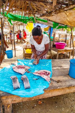 Toamasina, Madagaskar. 18 Ekim 2023. Yerel pazarda taze balık yiyecekler. Kadınlar taze balık temizler ve satar. Eller ve parçalar odak noktasında. Yerel aroma.