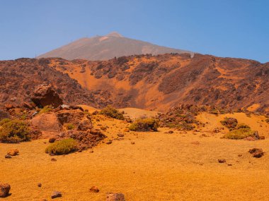 spot in Tenerife with many rocks and beautiful mountain landscape in the background. volcanic landscapes of Tenerife. summer nature backgrounds clipart
