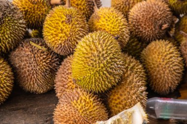 Olgun sarı durian meyveleri ahşap tezgahın üzerinde katlanmış satılıktır. Sri Lanka 'nın geleneksel meyveleri