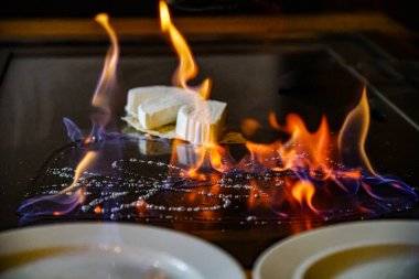 chef's hands with spatula over teppanyaki. cooking vegetables meat and seafood on hot hibachi grill table. Traditional Japanese. Teppan show. cuisine peoples of world concept clipart