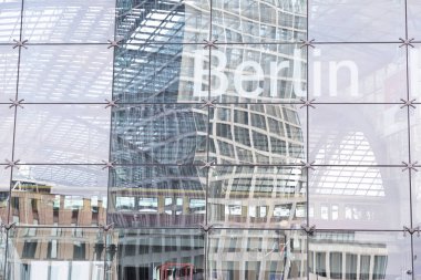 Berlin, Germany 20.03.2024 View of modern and architectural office building at Berlin Central Station. mirror reflection of an office building in a huge glass facade clipart