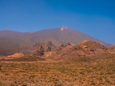 spot in Tenerife with many rocks and beautiful mountain landscape in the background. volcanic landscapes of Tenerife clipart