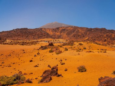 spot in Tenerife with many rocks and beautiful mountain landscape in the background. volcanic landscapes of Tenerife clipart