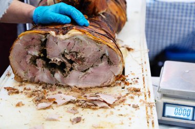 Büyük bir somun taze çiftlik jambonu ve sosis satışa hazır ve parça parça kesilmiş.