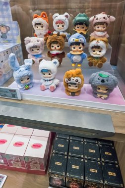 Berlin, Almanya. 27 Ağustos 2025. Market içi ziyaretçileri bakınıyor. Raflarda koleksiyon figürleri ve ürünler sergilenirken, cam anonslarda satılan Labubu serileri çeşitli tabelalar yer alıyor.