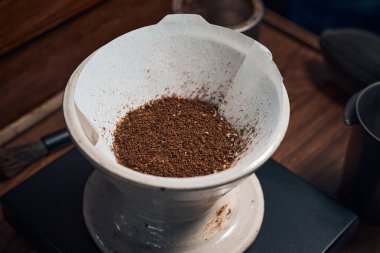 coffee powder in the dripper for make coffee filter on scales.