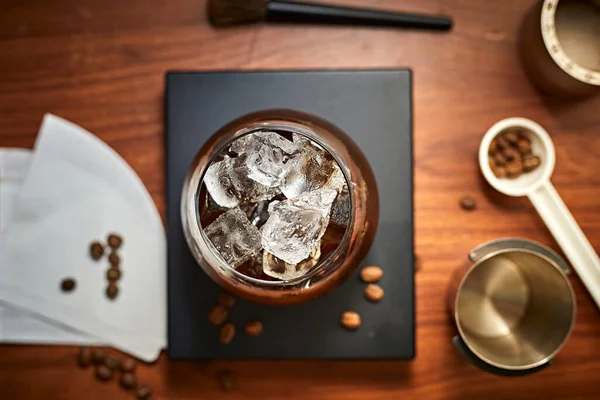 iced black coffee (iced americano) on the wooden table
