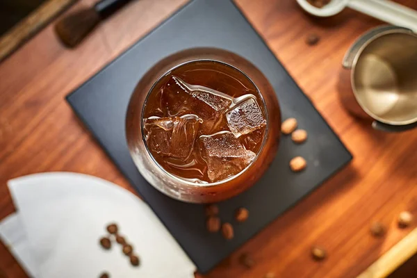iced black coffee (iced americano) on the wooden table
