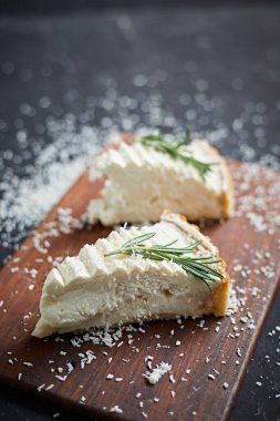 homemade coconut pie on black background